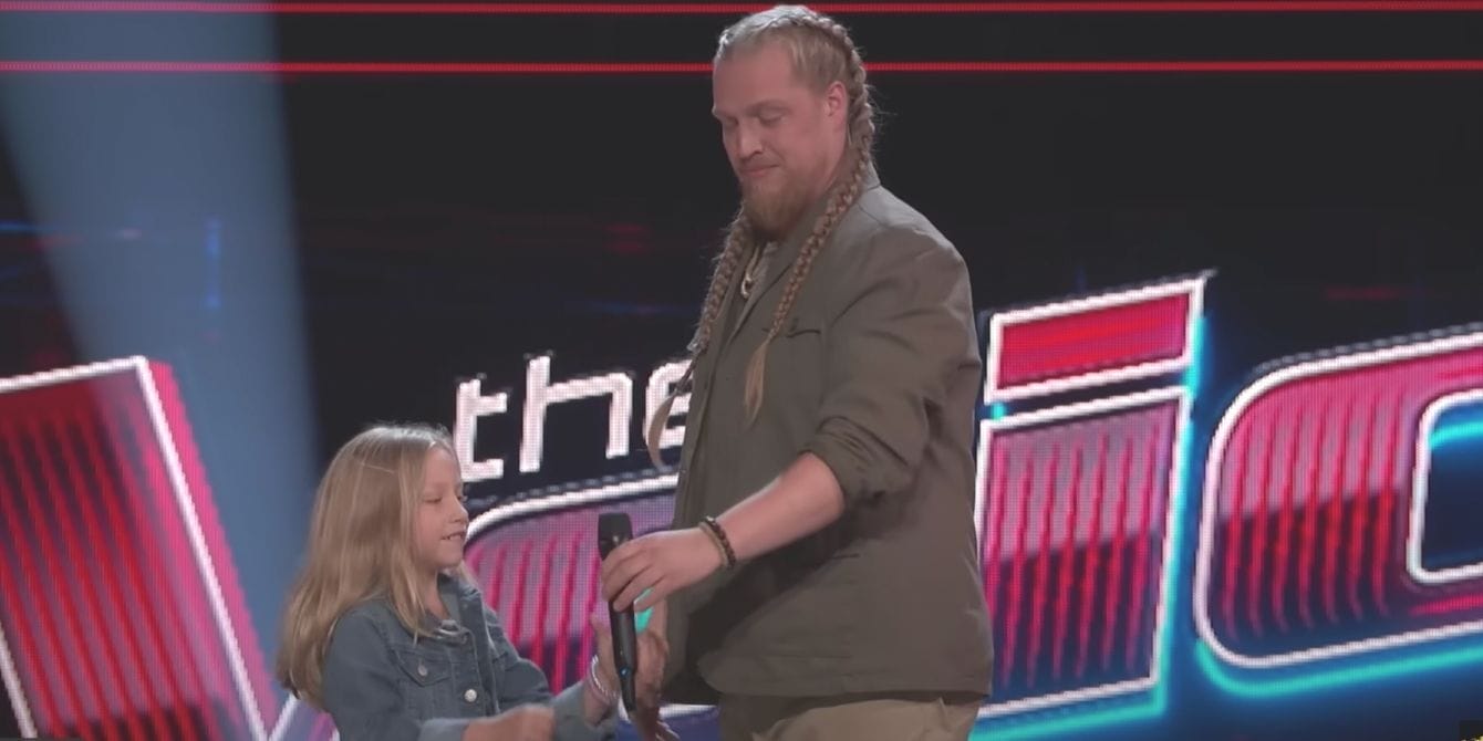 the voice-man giving microphone to his child