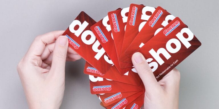 woman holding costco cards- costco gift card hack