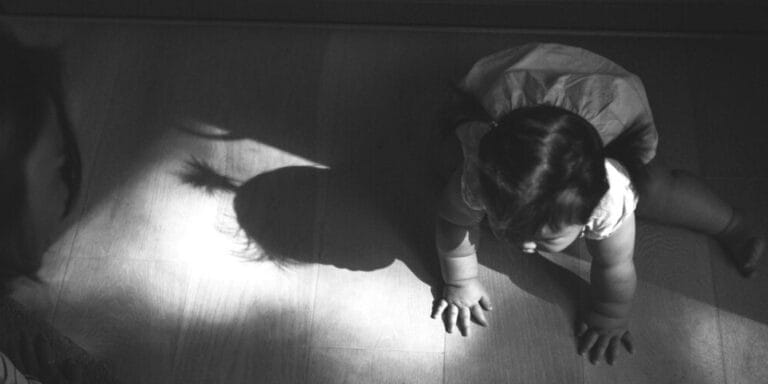 Baby playing in shadow