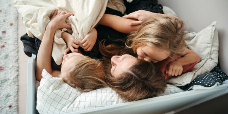 mom hugging kids in toddler bed difficult bedtimes effective bedtime methods