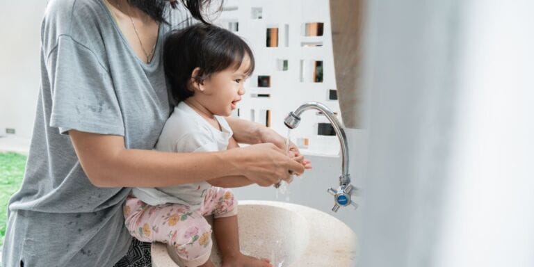 mom washing toddler's hands - potty training fails