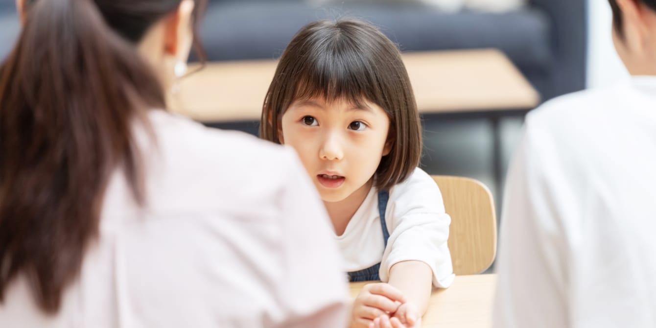 young girl having serious talk with her parents stranger danger