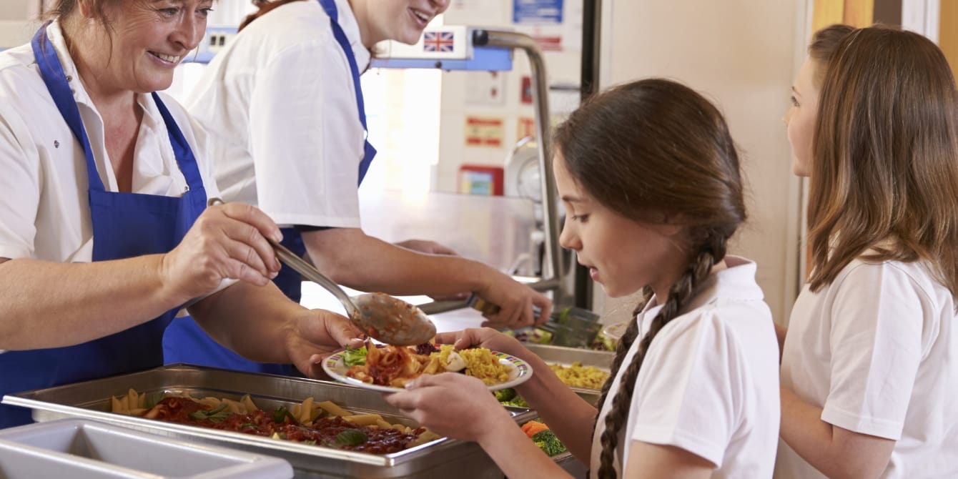 lunch lady serving girl food in cafeteria struggle to afford to pay for lunch