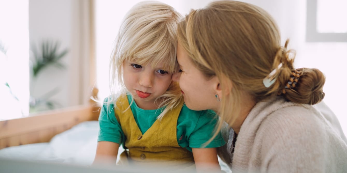 mom comforting sad young daughter how to reduce tantrums