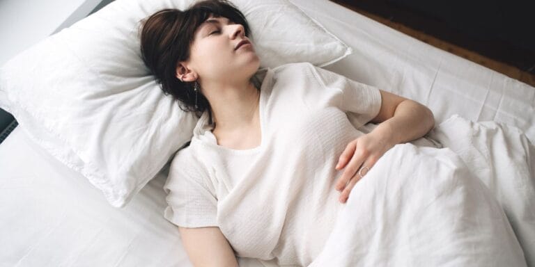 Woman with morning sickness in bed