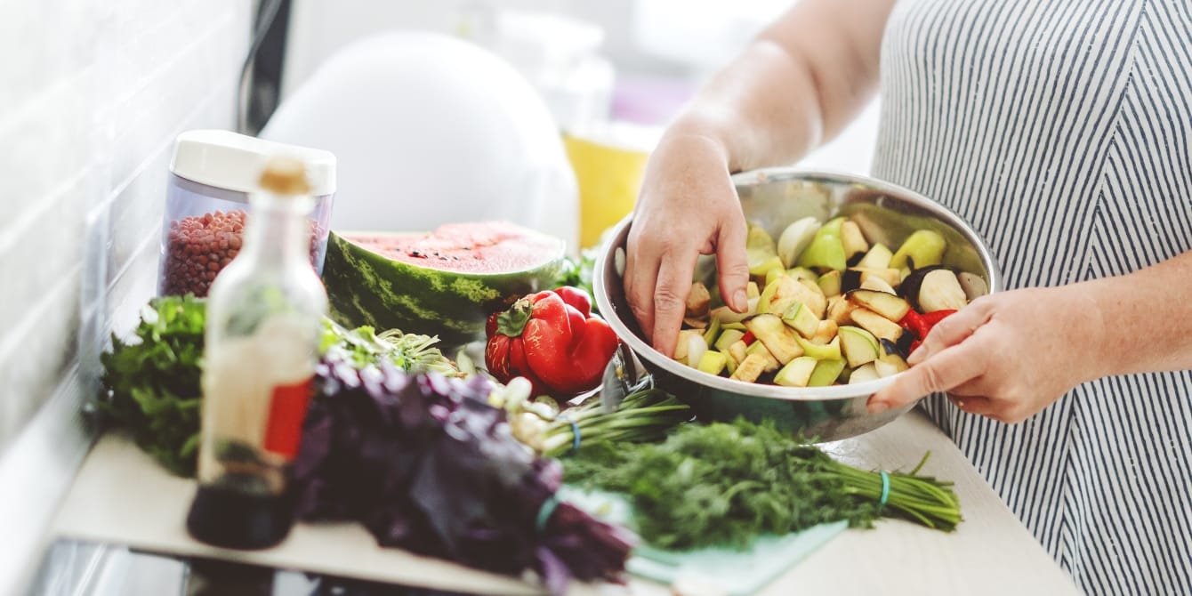 woman in kitchen cooking vegetables mediterranean diet for ivf