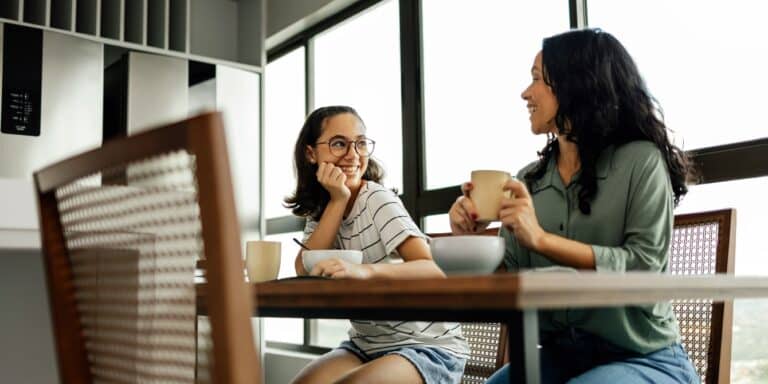 mom and teen daughter having breakfast parent child relationship