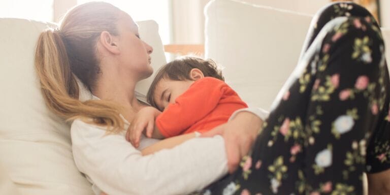 mom with toddler asleep on her lap