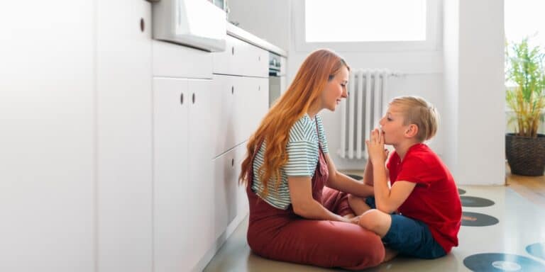 mother and son sitting on kitchen floor talking non-physical compliments