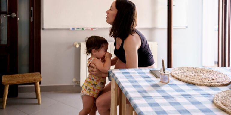 mom and frustrated toddler at home Motherly