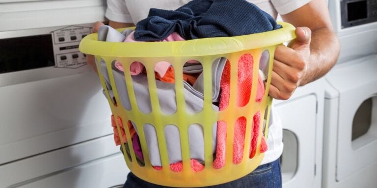 man holding laundry basket