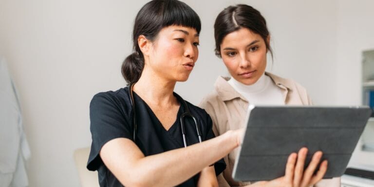 woman looking at medical results with her doctor ivf tips from obgyn