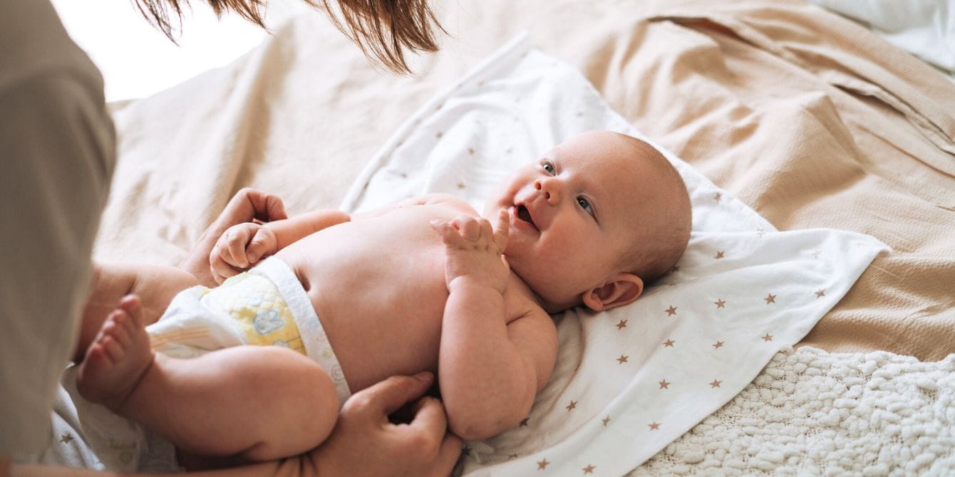 Mom changing baby's diaper