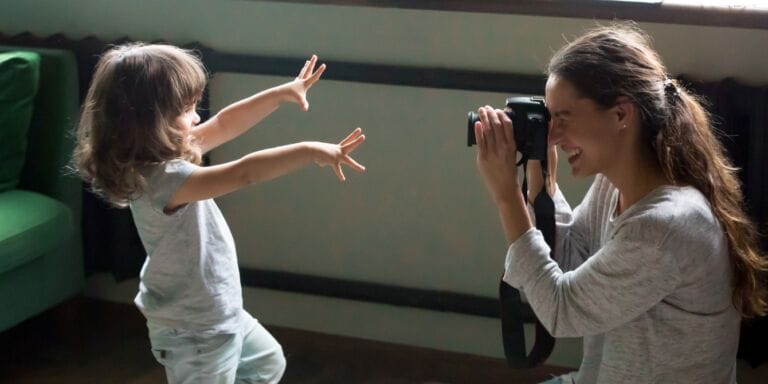 mom with a camera taking photo of child - playing memory keeper