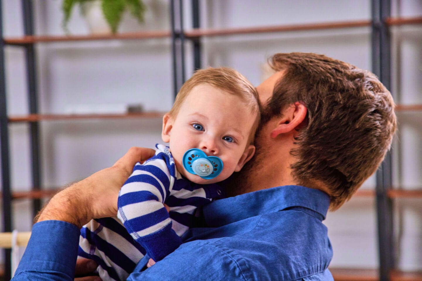 dad holding baby with MAM pacifier