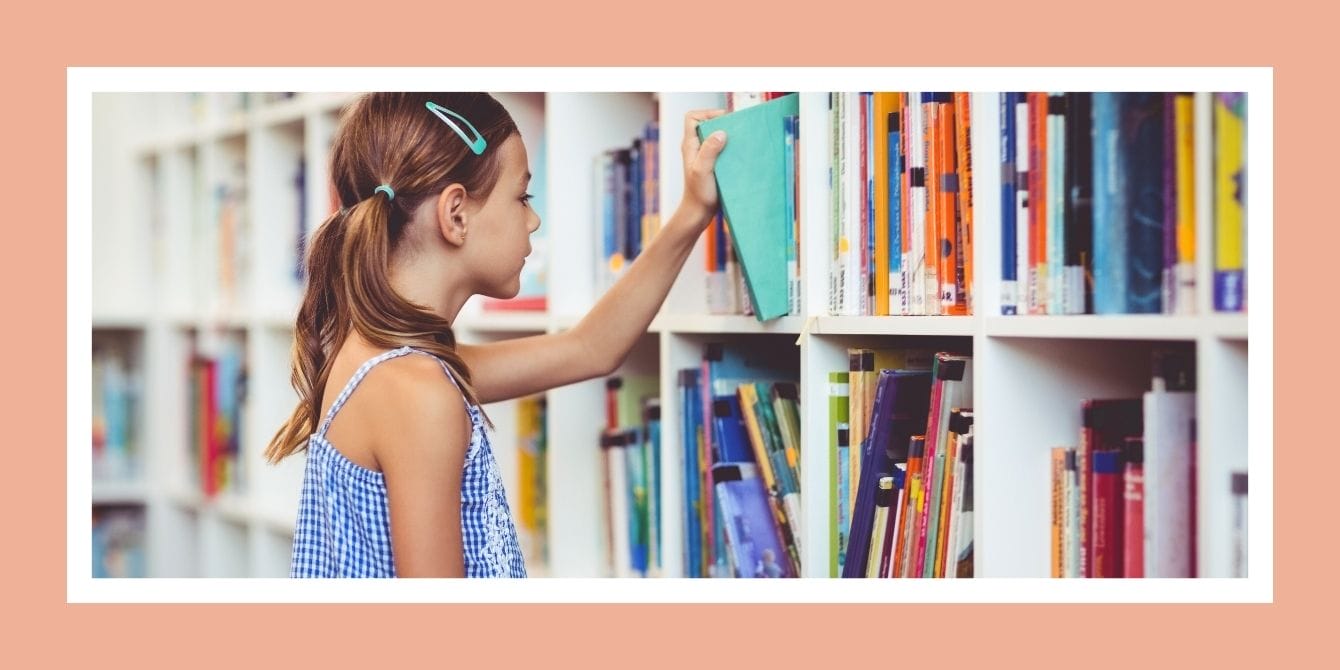 Girl picking a book from her school library