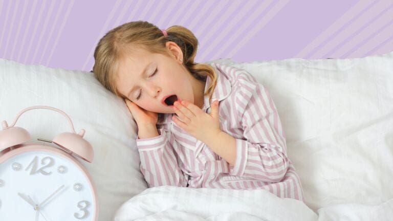 little girl yawning in bed on purple background