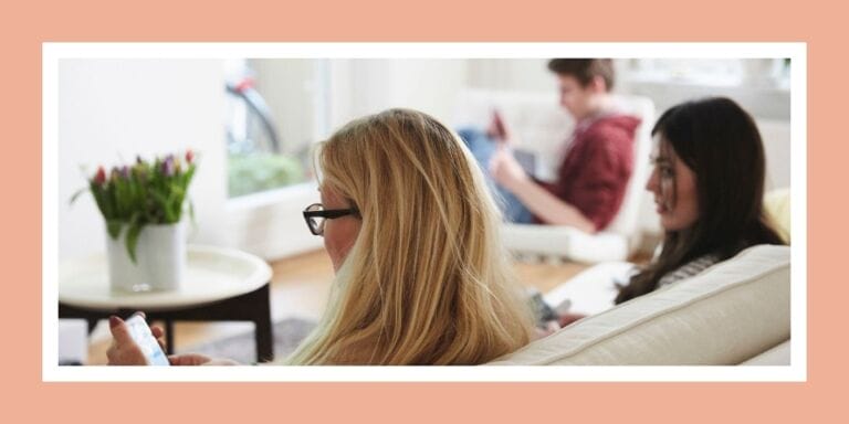 Mom and teens all on technology on the couch