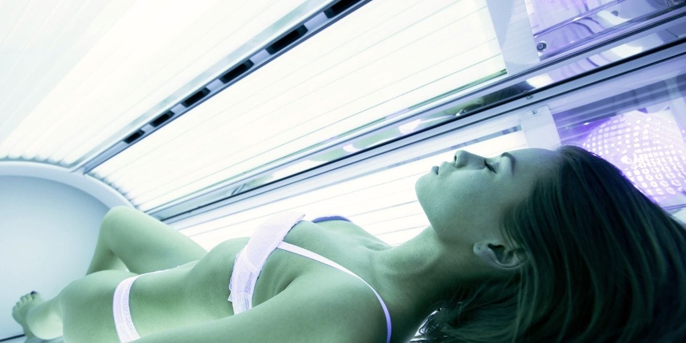 Teenager in tanning bed