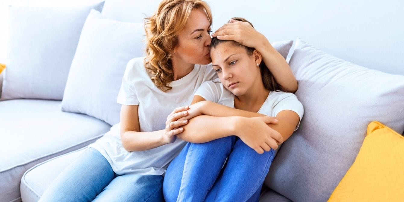 Mother comforting her teen daughter