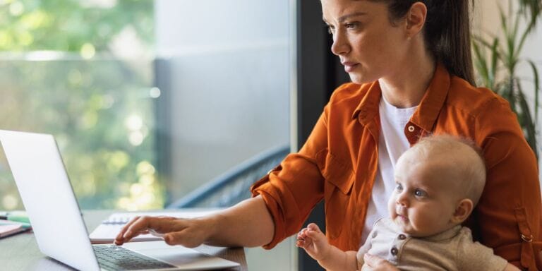 mother working with baby on lap - fmla for ppd