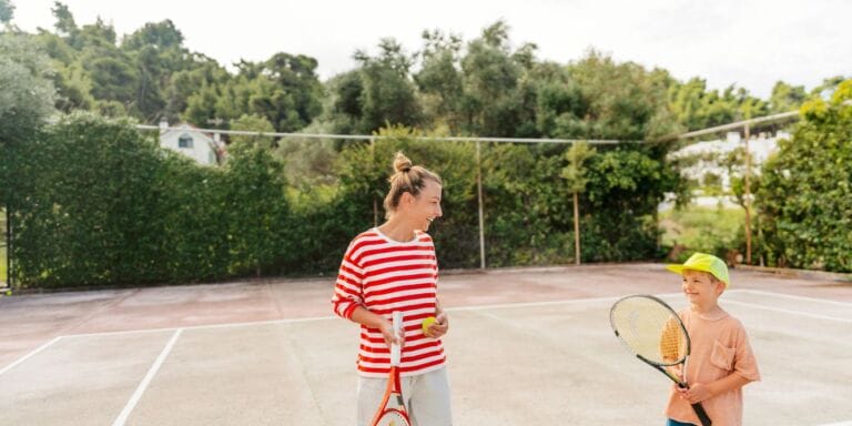 siding with son- mom and son playing tennis