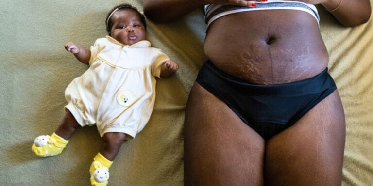 Black mother laying with baby