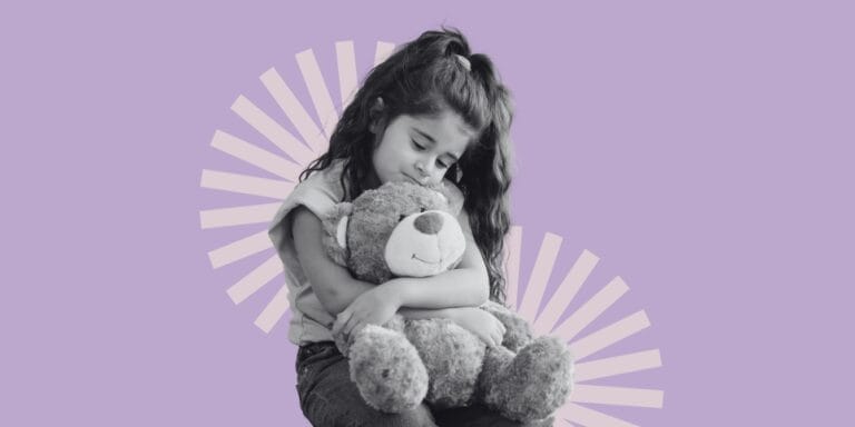 Glass child - a little girl hugging her teddy bear