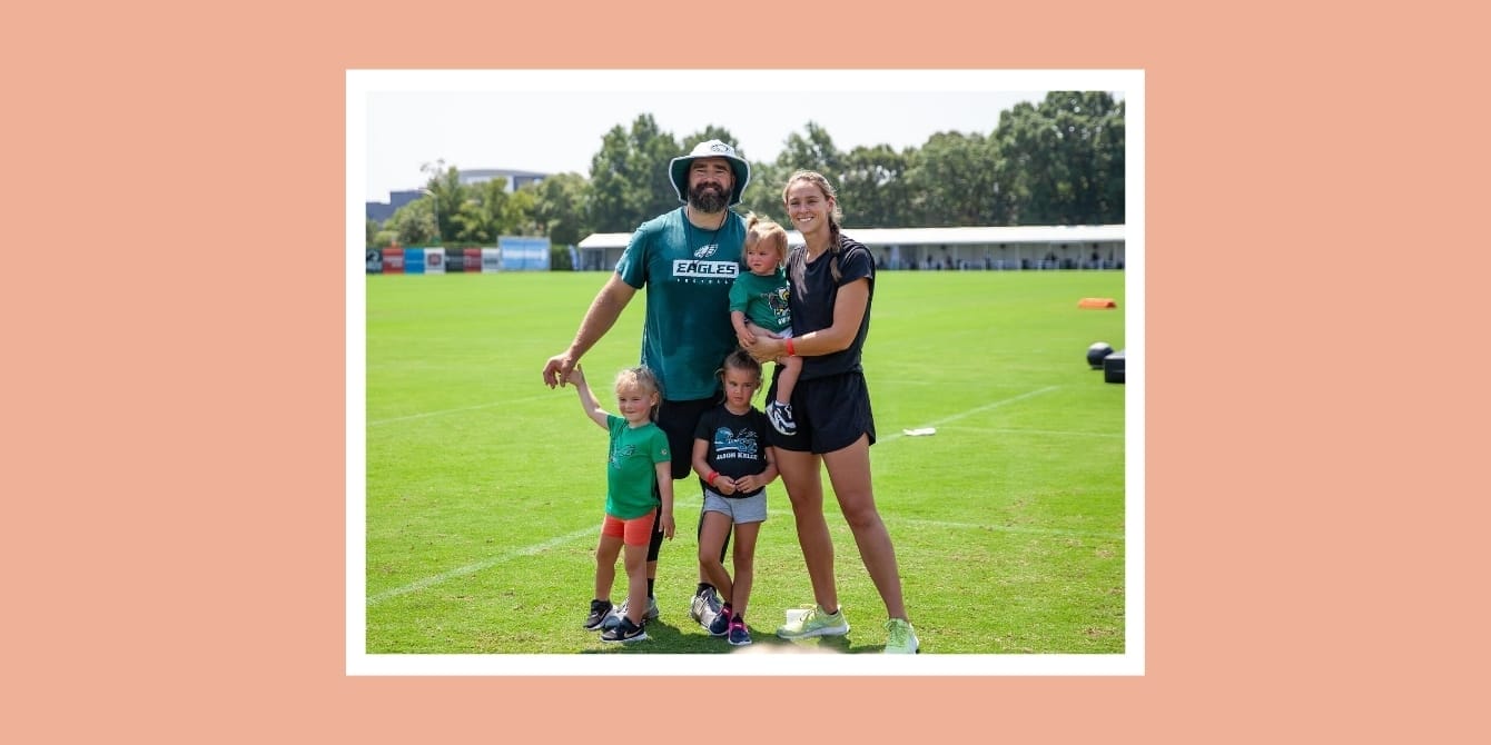 Jason Kelce and Kylie Kelce posing with their three daughters